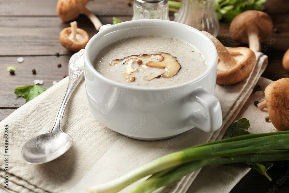 Bowl of creamy shiitake mushroom soup on table Bowl of creamy shiitake mushroom soup on table