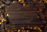 Garland lights with christmas decorations on grey wooden table