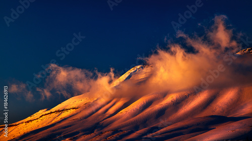 Fototapeta Naklejka Na Ścianę i Meble -  Beautiful sunset over snowy mountains