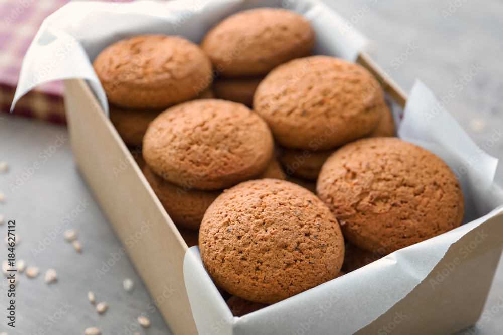 Box with delicious oatmeal cookies on table, closeup