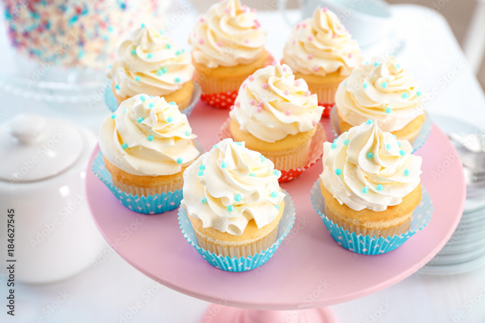 Stand with delicious cupcakes, closeup