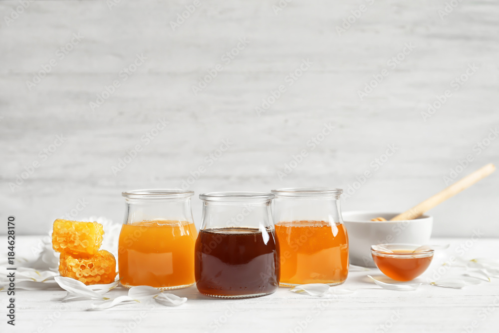 Composition with honey on white wooden background Composition with honey on white wooden background