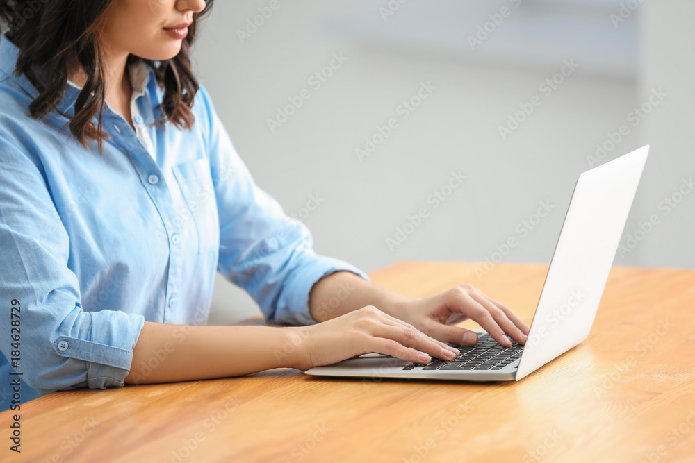 Young woman using laptop in office Young woman using laptop in office