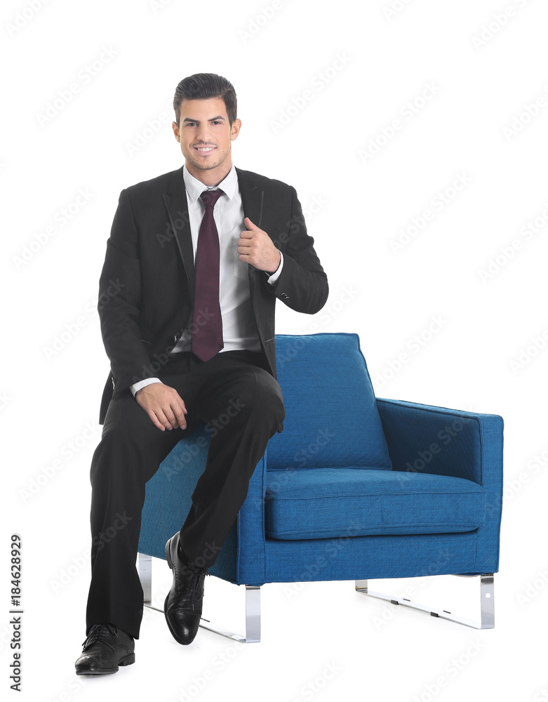 Handsome young man sitting on armchair on white background Handsome young man sitting on armchair on white background