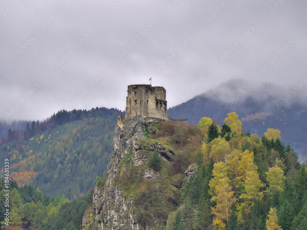 Beautiful view at the Strecno Castle in Slovakia with misty autumn mountains on the background.
