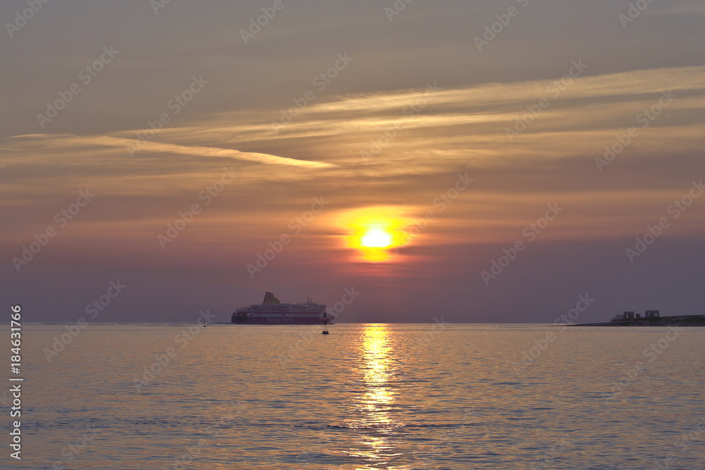 PAROS, GREECE - APRIL 14 2015:  Blue Star Ferries passanger ship sailing towards sunset near Paros Island.