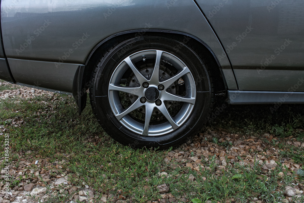 Sports car side view, alloy wheels