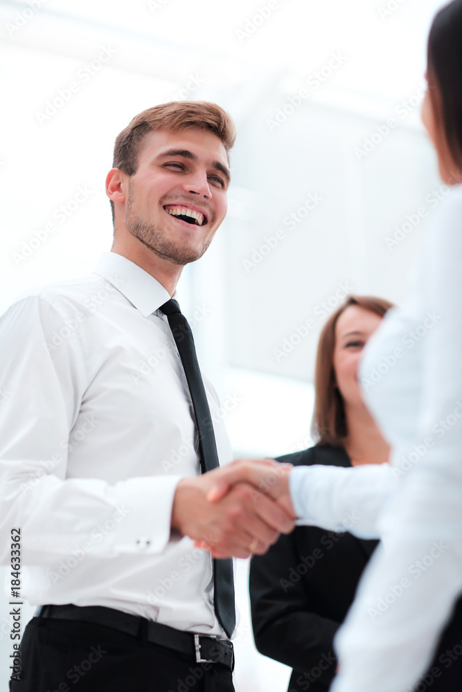 funny smiling businessman shaking hands with his partner. funny smiling businessman shaking hands with his partner.