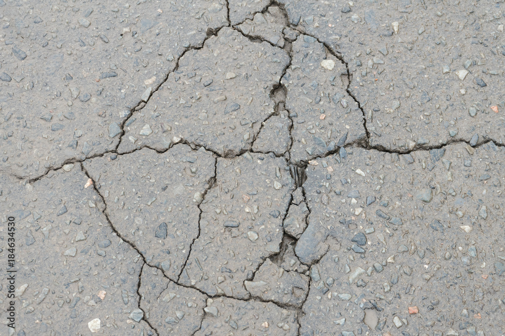 Fototapeta premium Cracks in the pavement. Poor road surfaces.