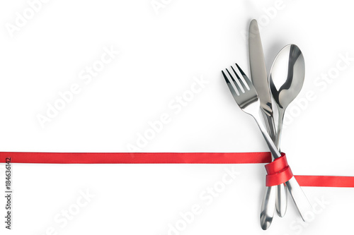 Obraz na płótnie Fork, spoon and knife tied with a red ribbon isolated with copy space w salonie