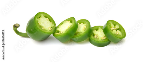 fresh green cut chili pepper pieces on a white background 