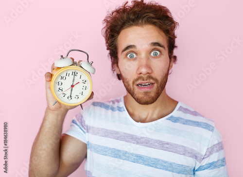 Shocked man posing with clock © kegfire