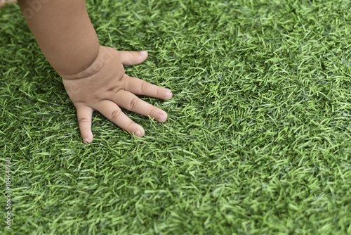 baby hand feeling the grass texture © Hafiez Razali