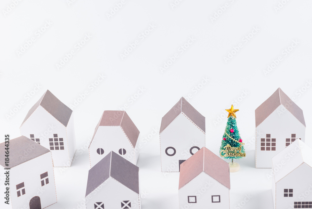 Christmas tree in the paper house town isolated on white background with copy space.Christmas day concept. Christmas tree in the paper house town isolated on white background with copy space.Christmas day concept.