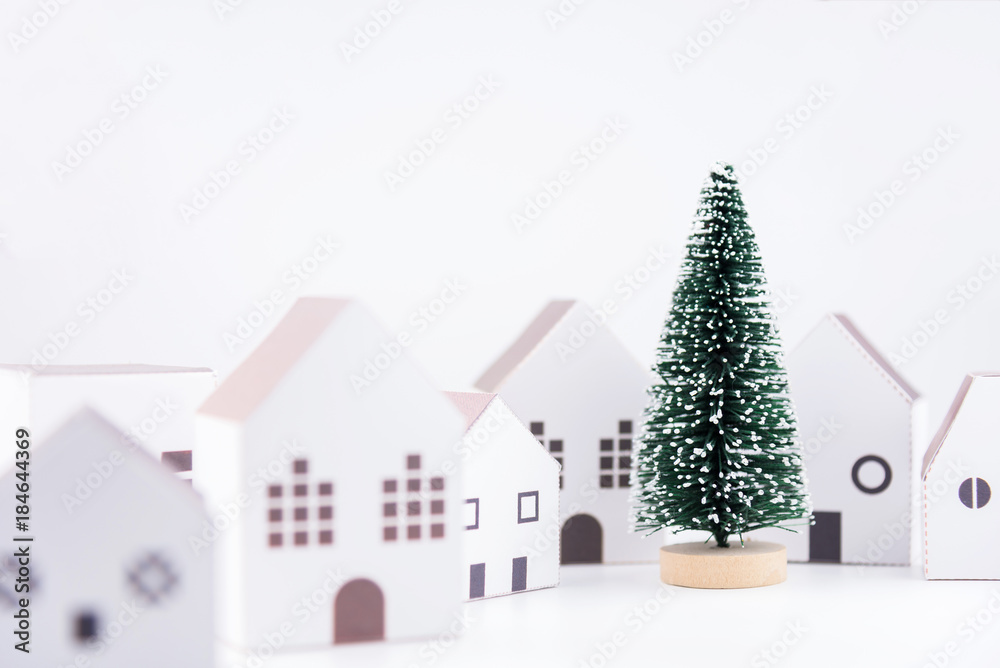 Christmas tree in the paper house town isolated on white background with copy space.Christmas day concept.