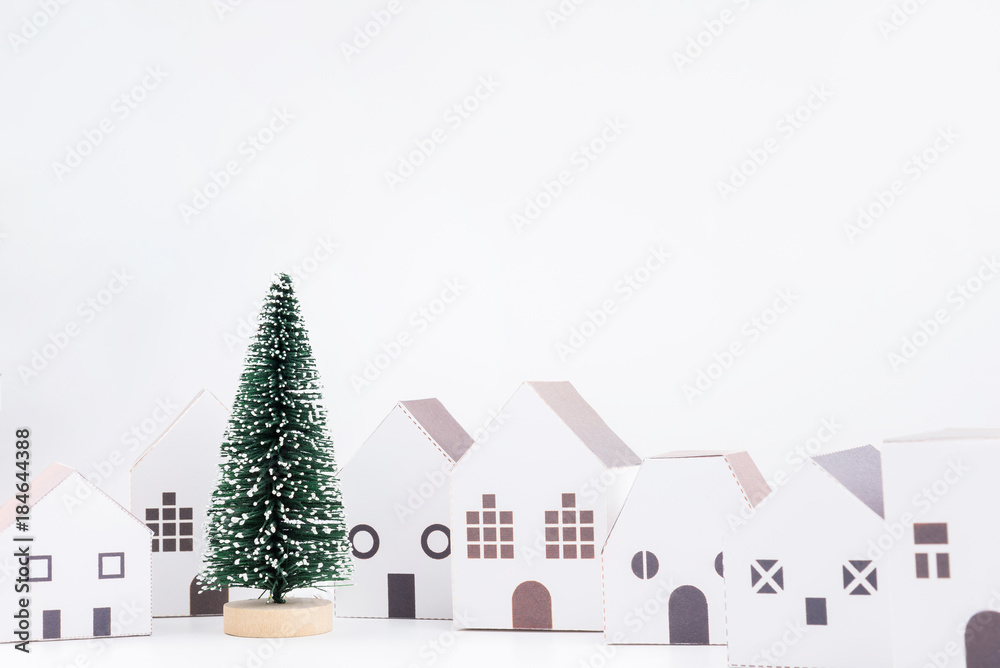 Christmas tree in the paper house town isolated on white background with copy space.Christmas day concept.
