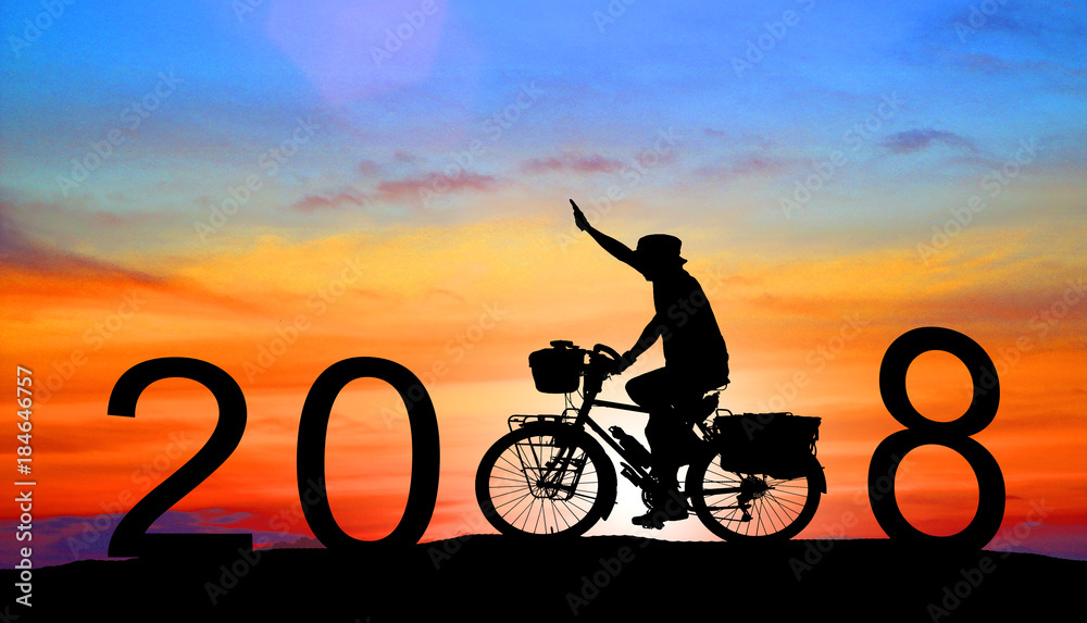 Obraz premium silhouette man driving with a bicycle,Happy new year 2018 concept.