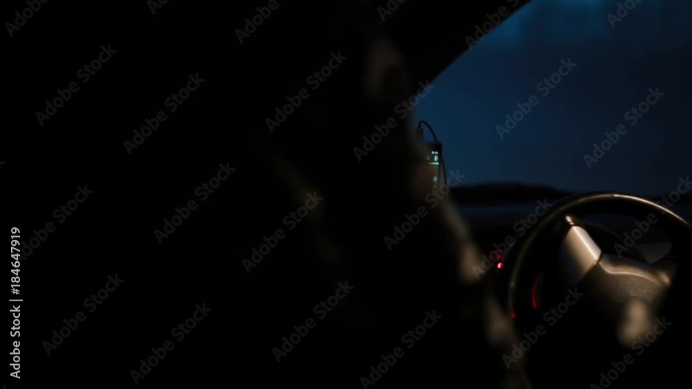 POV Female driver getting in a car at night. Female face reflecting in side mirror. Before a long trip with gps map.