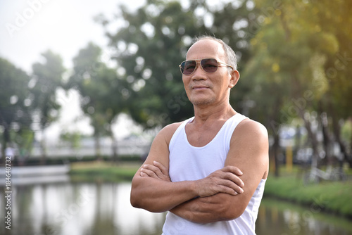 Asian Senior male posing with arms crossed.