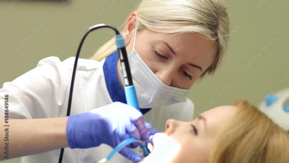 Close-up of the face of the dentist working with the patient in the clinic.