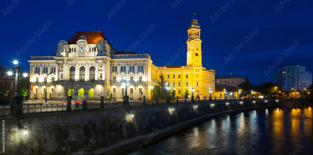 Oradea City Hall on embankment in twilight