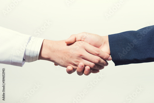 Man doctor and her lawyer shaking hands on white.