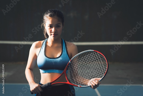 Young woman asia holding tennis racket.