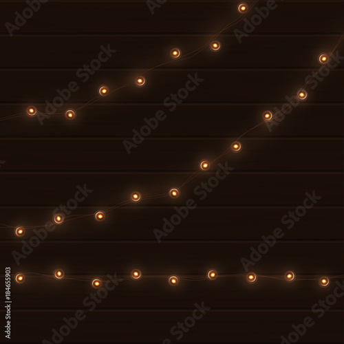 Vector vintage light garland on brown wooden background.