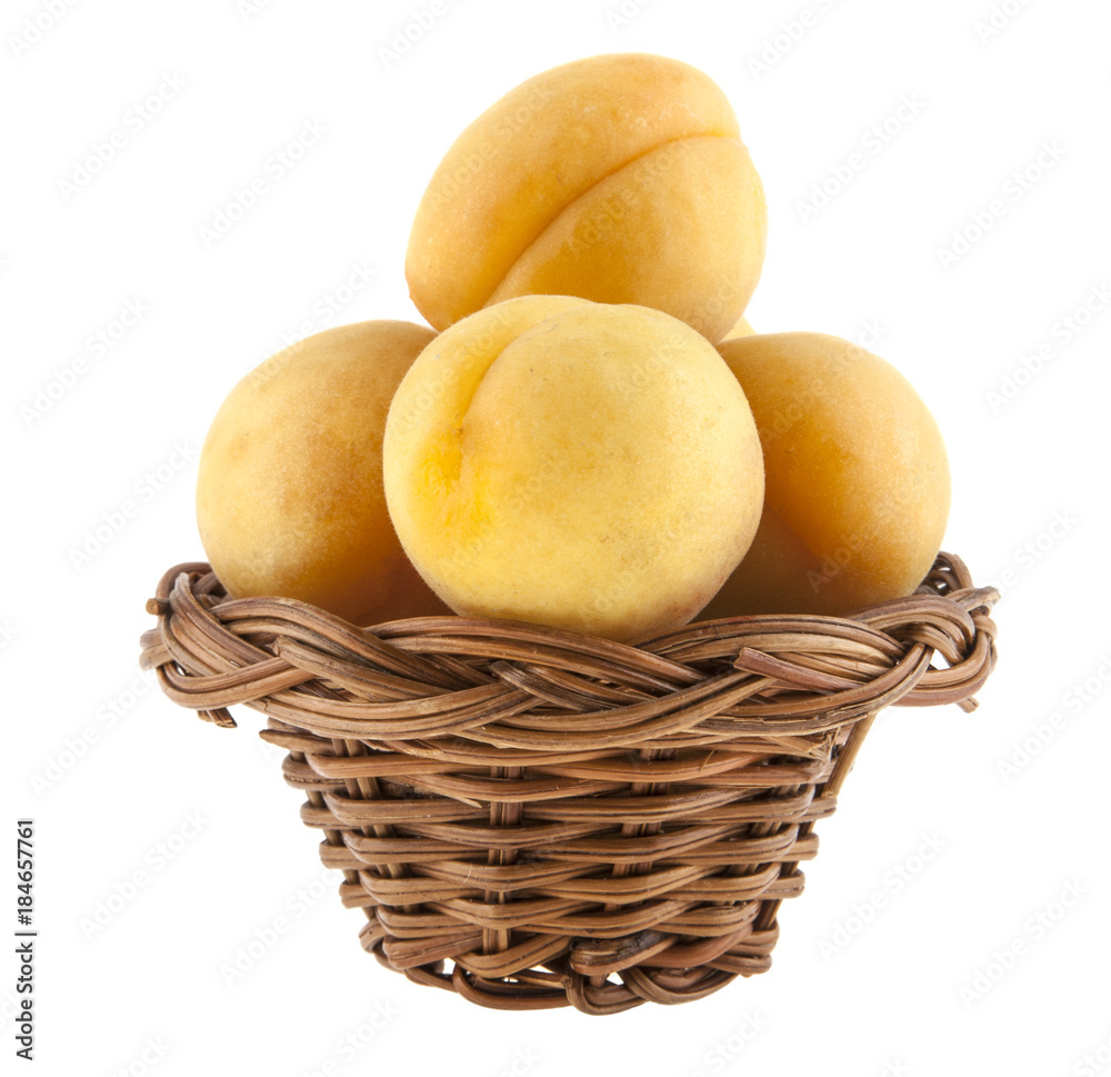 apricot in wicker basket isolated on white background apricot in wicker basket isolated on white background