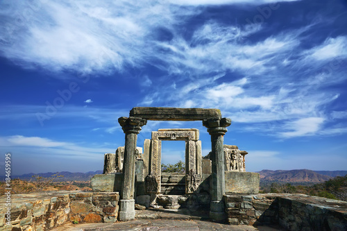 Indian architecture. Antique arch of old destroyed hindu temple with a blue sky and clouds on a background, India, Rajasthan. For background, screen saver, desktop theme