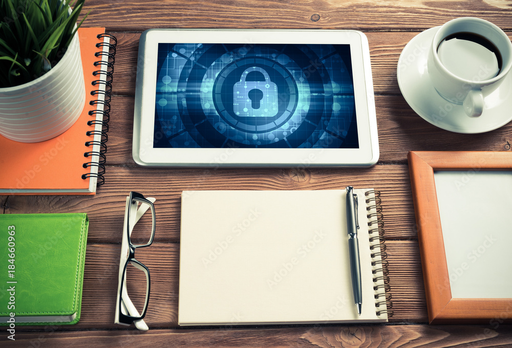 Web security and technology concept with tablet pc on wooden tab Web security and technology concept with tablet pc on wooden tab