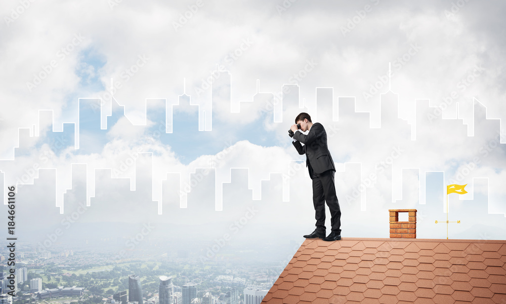 Businessman standing on roof and looking in binoculars. Mixed media Businessman standing on roof and looking in binoculars. Mixed media