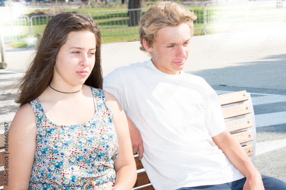 A young couple relaxes on a bench A young couple relaxes on a bench