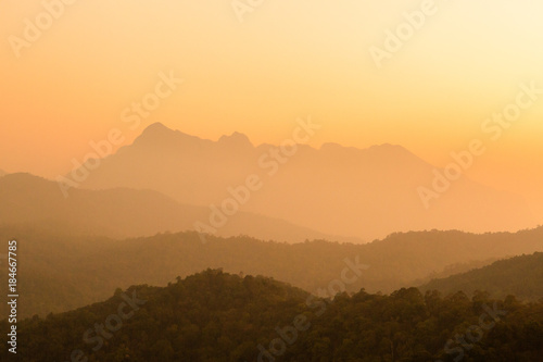Landscape of mountain layer in morning sunrise and winter fog