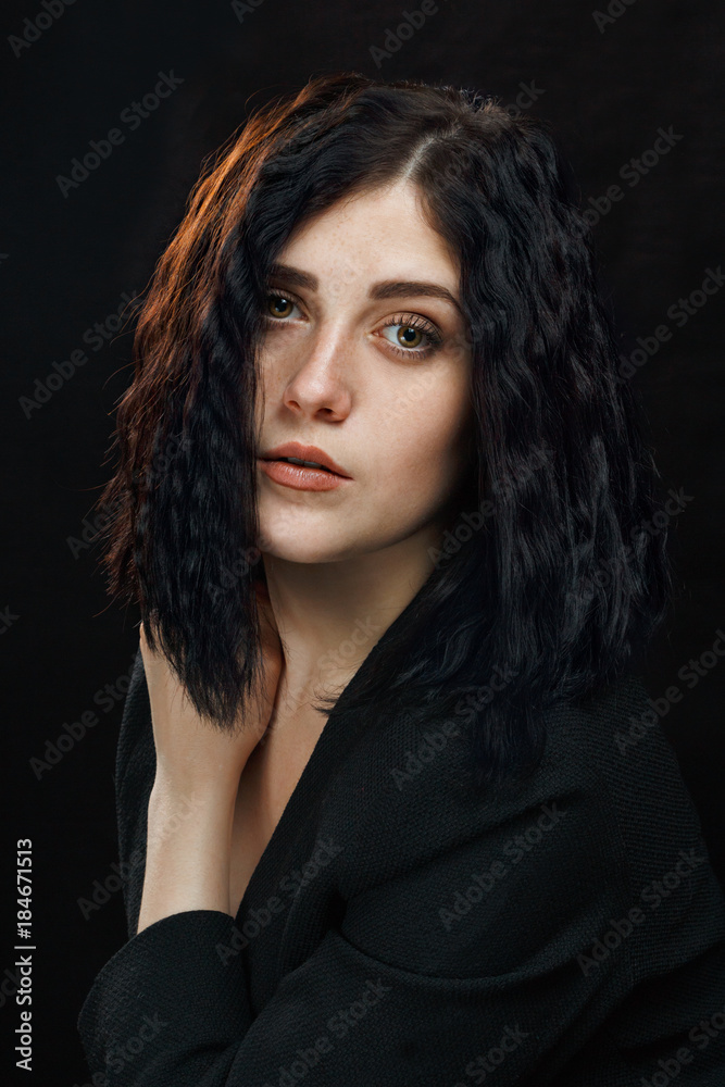 Beautiful young girl on a dark background. Studio photo of a beautiful girl Beautiful young girl on a dark background. Studio photo of a beautiful girl