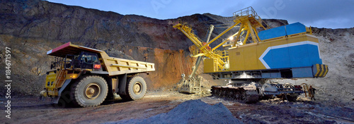 Excavator loads rock in the dumper