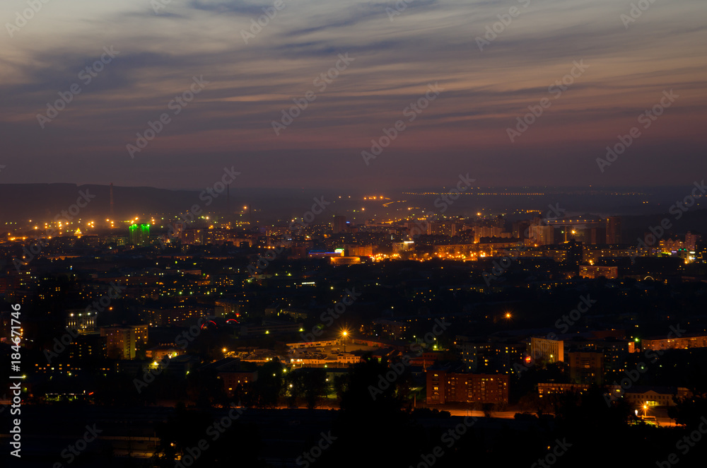 Beautiful background of night sky with stars and the lights of the city homes summer