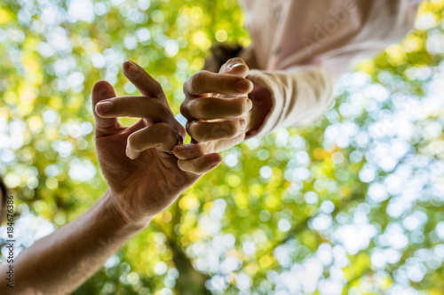Photos Man and woman walking along with linked fingers in a sign of affection and love