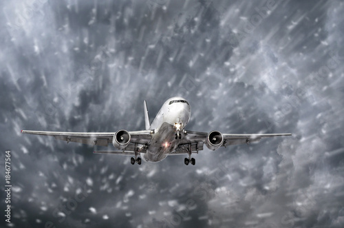 Airplane approaching on a landing in snowstorm bad weather. photo