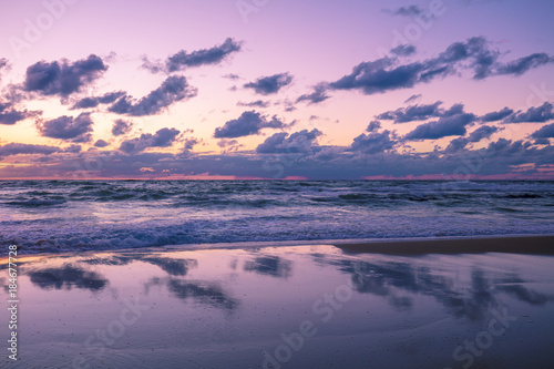 Beautiful beach in evening with reflection. The time after sunset