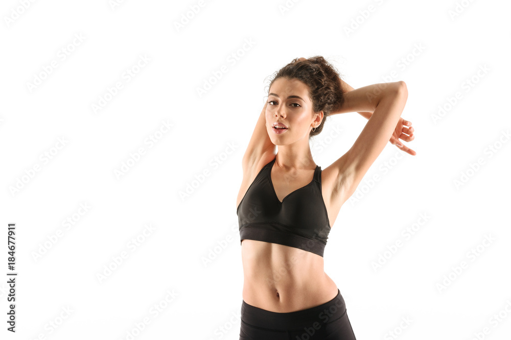 Smiling fitness woman warming up in studio Smiling fitness woman warming up in studio