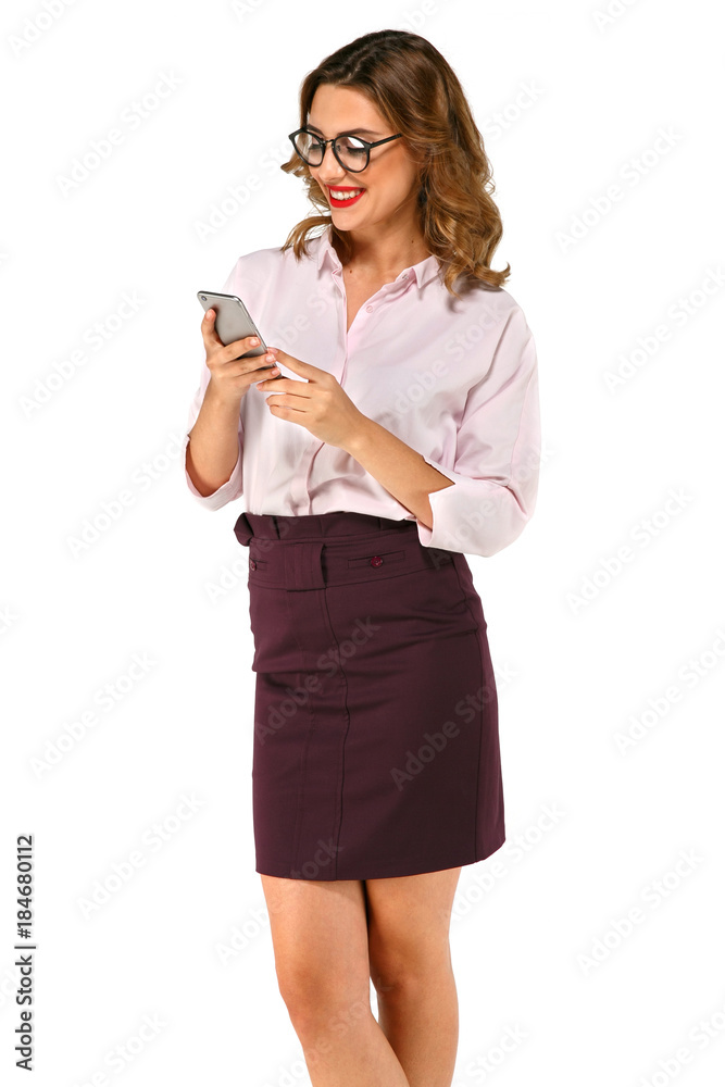 Beautiful and smilling business woman using her cell phone in glasses, dressed in strict clothes, isolated on white background Beautiful and smilling business woman using her cell phone in glasses, dressed in strict clothes, isolated on white background