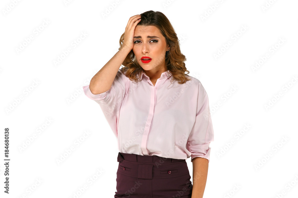 Disappointed young and beautiful woman looks frustrated, depressed and holds her head with hand on white background Disappointed young and beautiful woman looks frustrated, depressed and holds her head with hand on white background