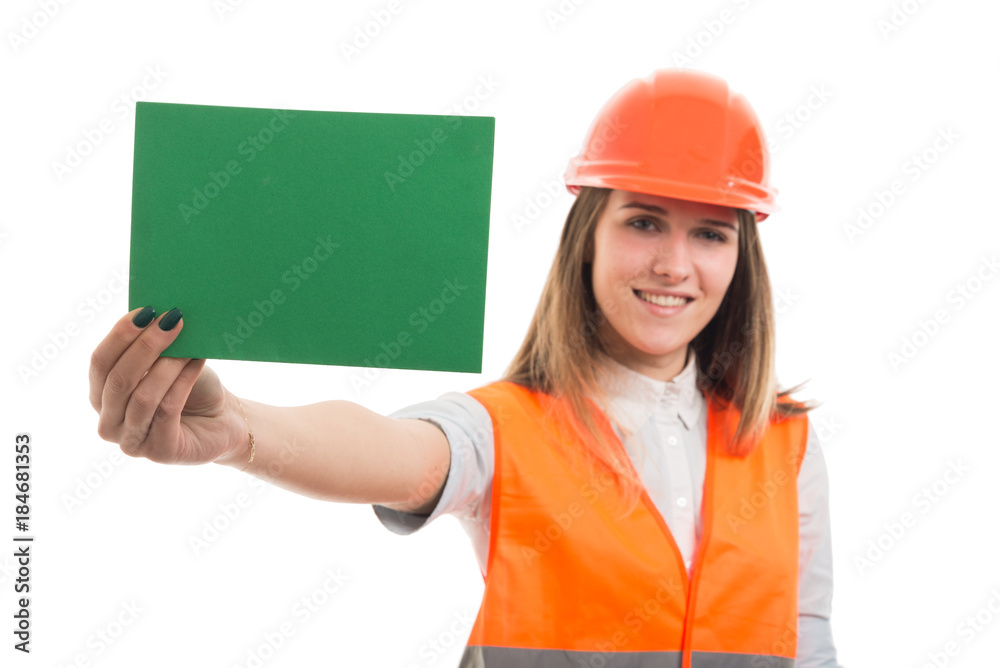 Beautiful young girl constructor showing blank paper Beautiful young girl constructor showing blank paper