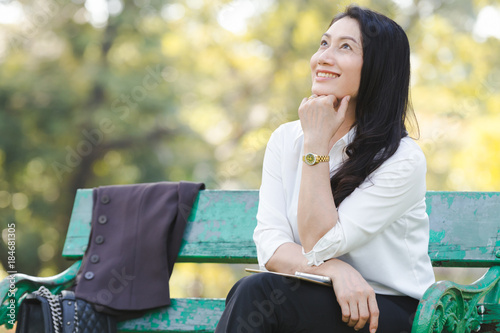 Asian beautiful business woman relaxation in park