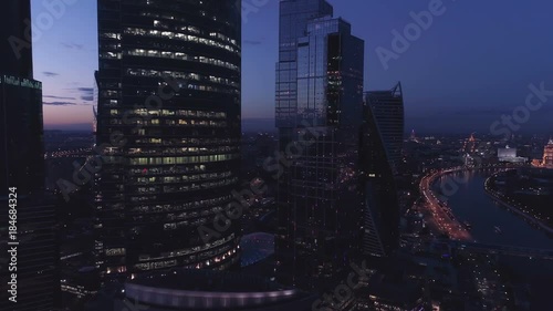 A night drone Aerial shot of skyscrapers of Moscow International Business Centre, Moscow-city, 4K Ultra HD real time video. Urban scene of consulting company office. Camera moving backwards.