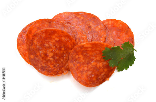 Slices of pepperoni on white background 