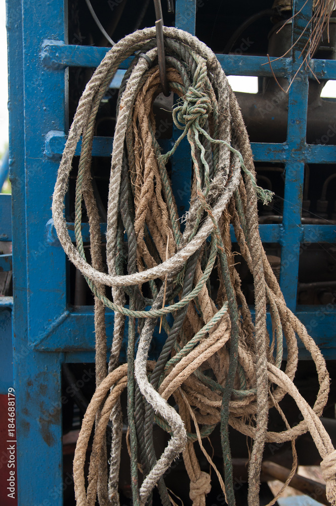 Many rope hang on a hook.