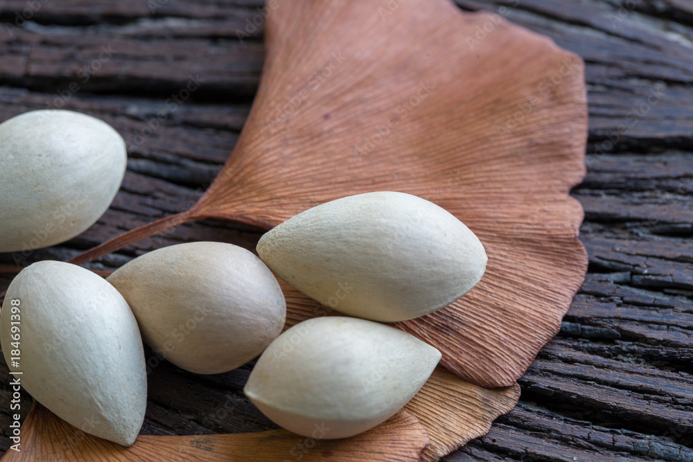Ginkgo biloba (seeds) on the background wood.
