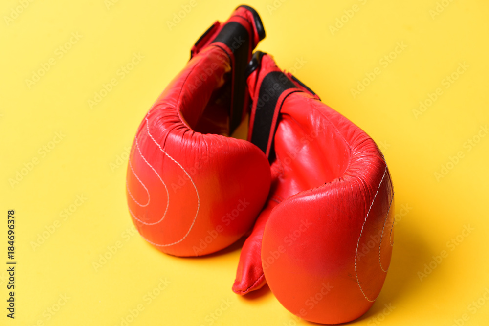 Pair of boxing gloves lying next to each other.